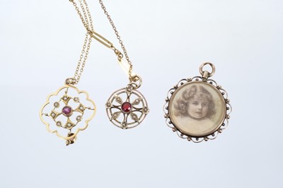 Lot 563 - Two Edwardian gold garnet and seed pearl pendants on chains, together with an Edwardian double-sided portrait locket.