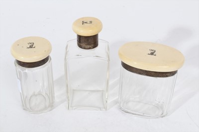 Lot 384 - Three ivory lidded glass dressing table jars