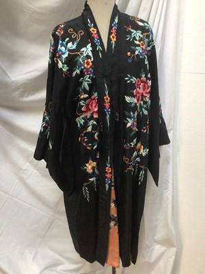 Lot 1901 - Chinese black silk robe with polychrome silk embroidered flowers, reversible orange silk with flowers.