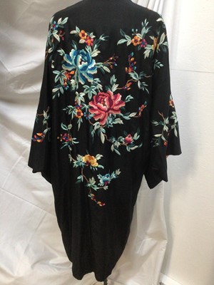 Lot 1901 - Chinese black silk robe with polychrome silk embroidered flowers, reversible orange silk with flowers.