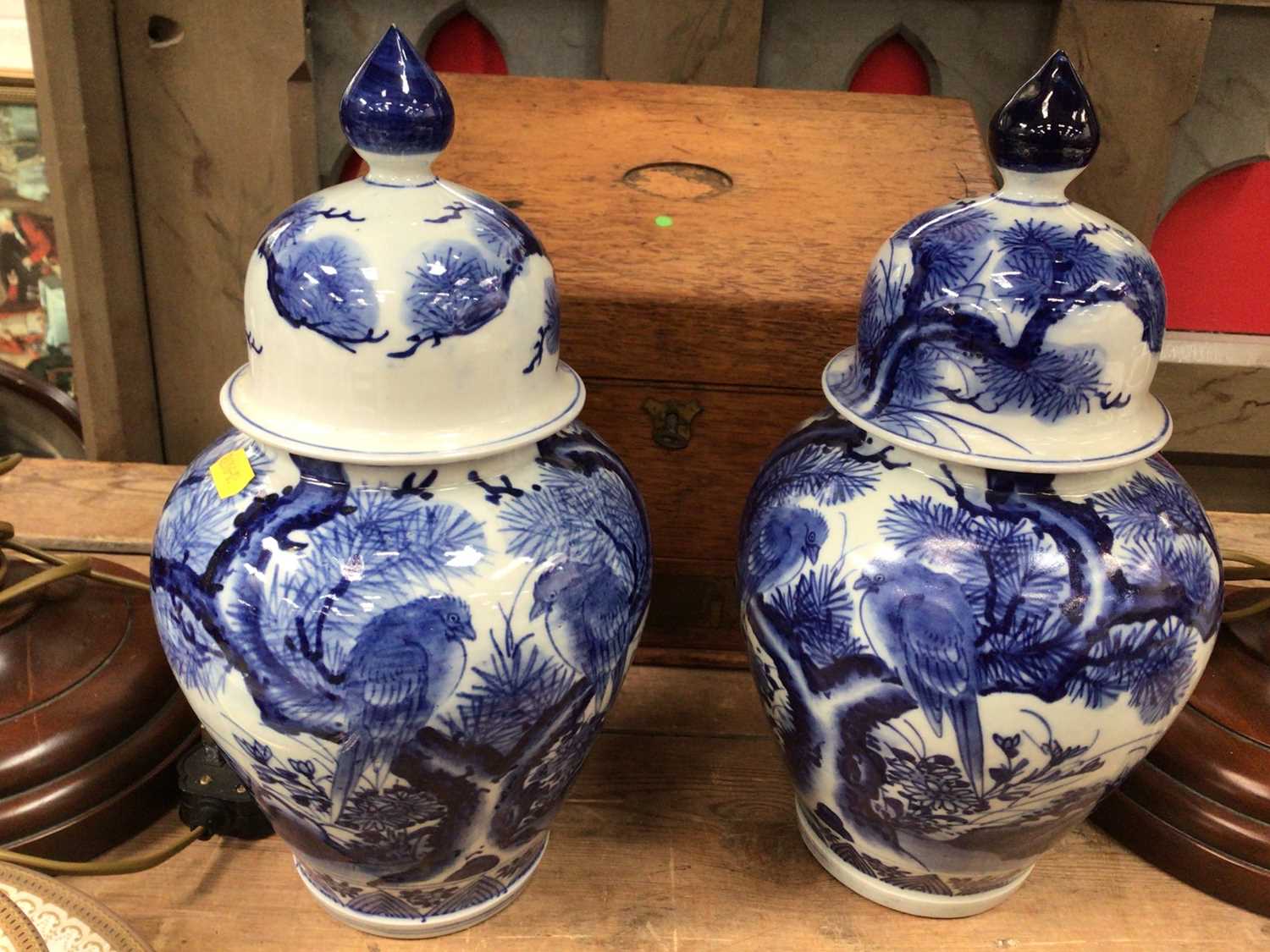 Lot 28 - Pair of oriental blue and white urns and covers