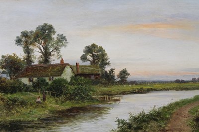 Lot 1111 - Daniel Sherrin (1868-1940) oil on canvas - figure beside riverside cottages