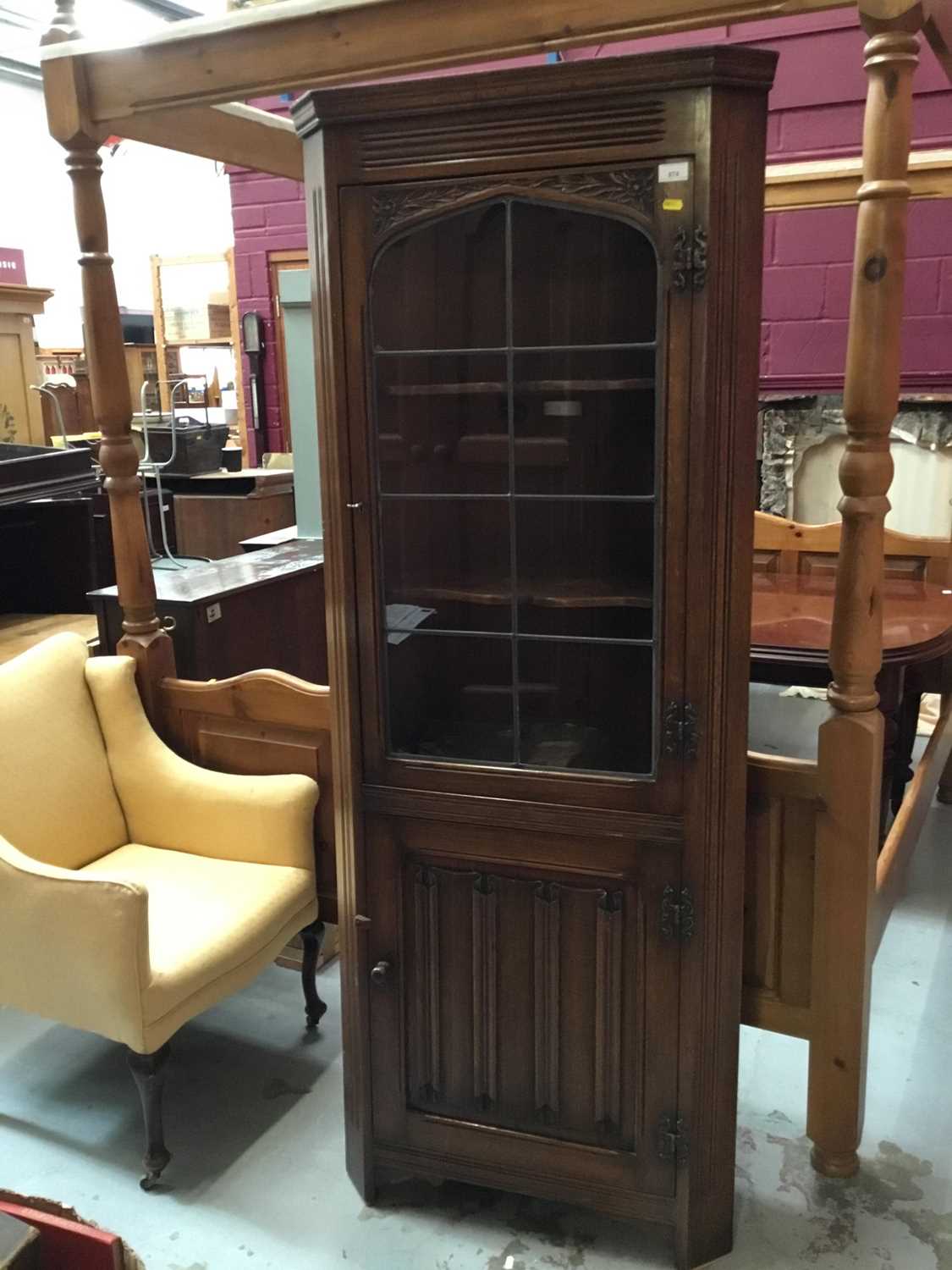 Lot 874 - Old Charm carved oak two height corner cabinet with leaded glazed door and linen fold door below 182 cm high, 72 cm wide