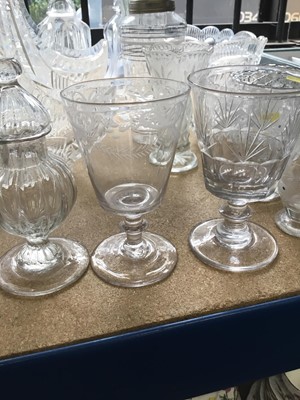 Lot 200 - Collection of cut glass and pressed glass wares to include decanters, cake stands and other pieces