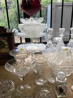 Lot 200 - Collection of cut glass and pressed glass wares to include decanters, cake stands and other pieces