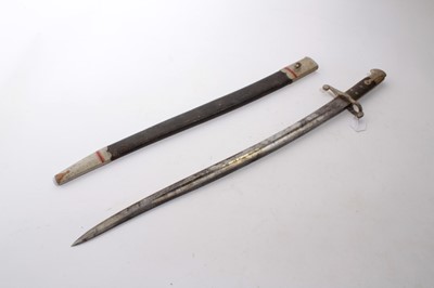 Lot 859 - Victorian 1853 pattern Enfield bayonet for the Martini Henry rifle, with fullered blade and black checkered grip, in leather scabbard (with later painted decoration).