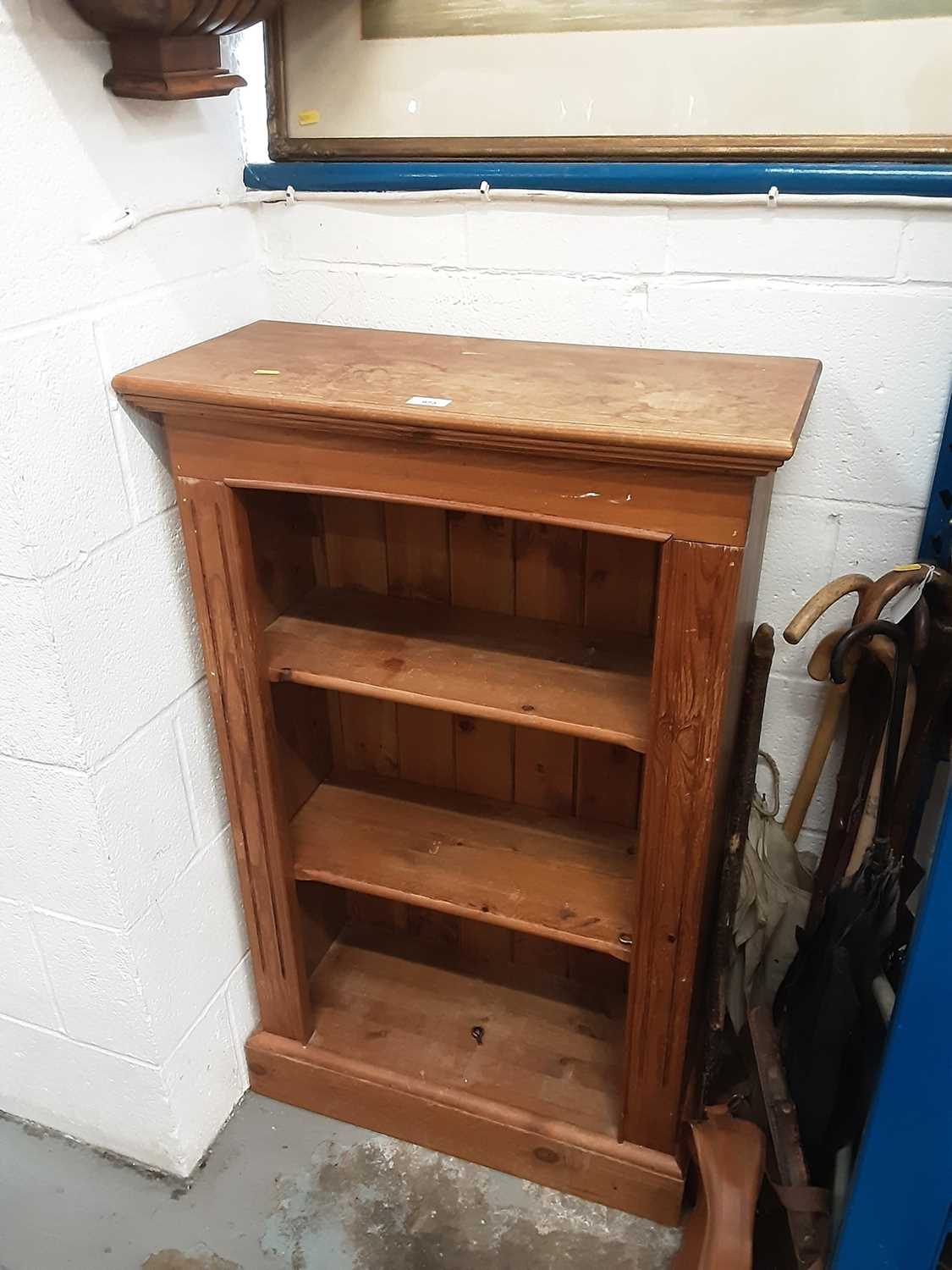 Lot 973 - Pine book case on plinth, pillar uprights, tongue and grooved back and two adjustable shelves, 65 cm wide