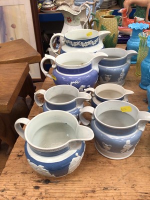 Lot 11 - Collection of Victorian pottery jugs, including seven graduated relief moulded jugs, two majolica sweetctorn jugs, and three more (12)