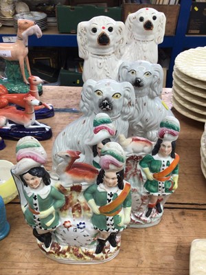 Lot 15 - Two pairs of Staffordshire pottery spaniels, and a pair of Staffordshire clock groups (6)