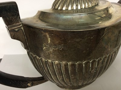 Lot 687 - Victorian silver teapot of half fluted form with angular ebony handle. Approx 20oz