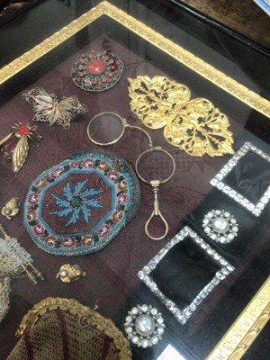 Lot 45 - Unusual framed display of Victorian objects, including beadwork purses, buckles, brooches and spectacles, 41cm x 36cm