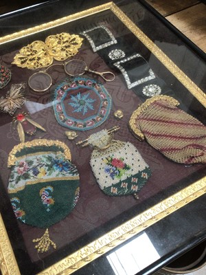 Lot 45 - Unusual framed display of Victorian objects, including beadwork purses, buckles, brooches and spectacles, 41cm x 36cm