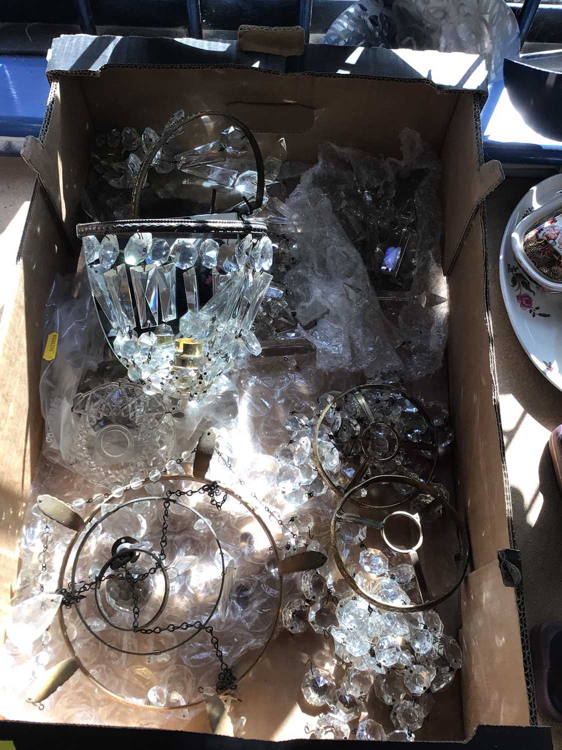 Lot 65 - Box of crystal pendant chandeliers and wall lights, some parts loose