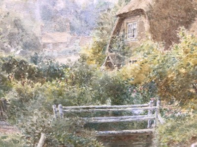 Lot 198 - Charles Gregory (1849-1920) - watercolour in glazed gilt frame - idyllic rural landscape with child and figures by stream with cottages and church beyond, titled 'Houghton Hunts'