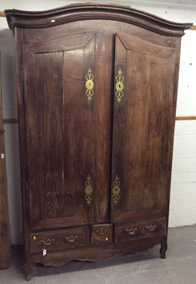 Lot 1072 - Late 18th / early 19th century French chestnut armoire, with arched cavetto moulded cornice and enclosed by a pair of doors over three short drawers, on shaped apron and stiles, approximately 152cm...