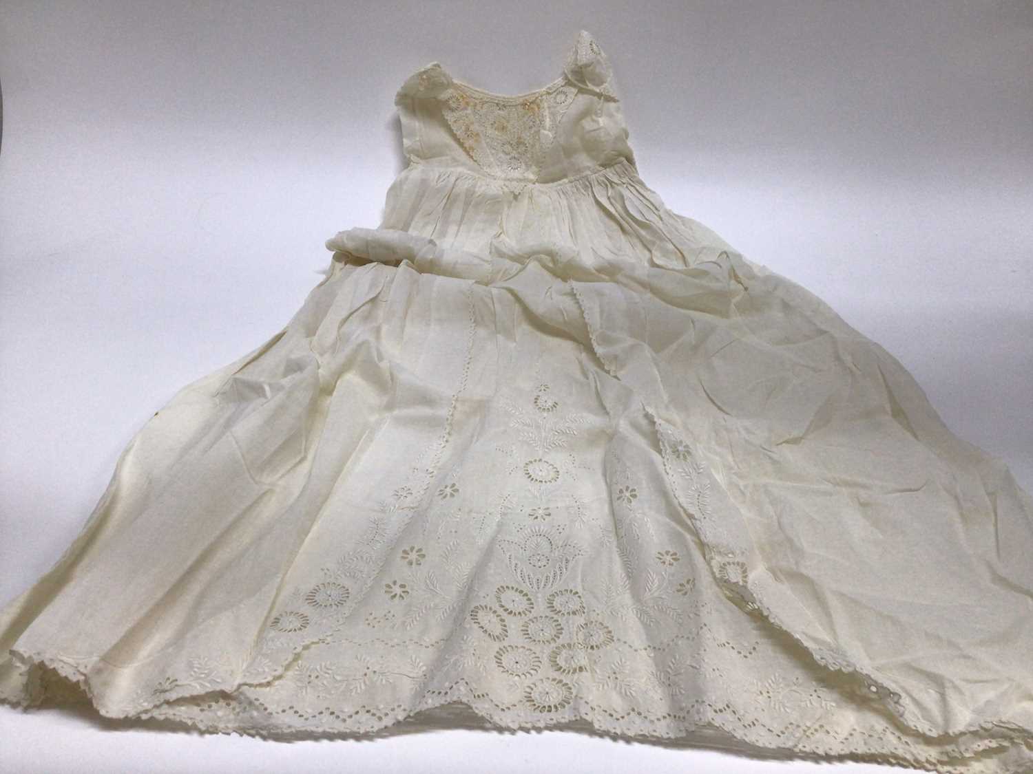 Lot 1929 - Antique White work Christening Gown with petticoat and embroidered cream wool shawl. Also an appliqued net lace wedding dress train, motifs include Thistles, Lily of the Valley, Bows and Shamrock....