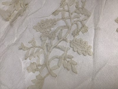 Lot 1929 - Antique White work Christening Gown with petticoat and embroidered cream wool shawl. Also an appliqued net lace wedding dress train, motifs include Thistles, Lily of the Valley, Bows and Shamrock....