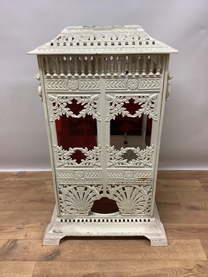 Lot 1355 - Victorian white painted cast iron conservatory heater, titled Veritas Stove, in the aesthetic taste, of square pillar form with elaborate geometric and foliate ornament and coloured glass inset pan...