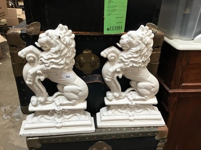 Lot 596 - Pair impressive cast iron lion door stops and lot stair carpet retainers