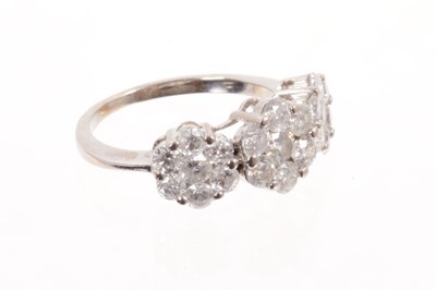 Lot 574 - Diamond cluster ring with three diamond set flower head clusters in white gold setting