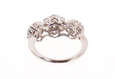 Lot 574 - Diamond cluster ring with three diamond set flower head clusters in white gold setting