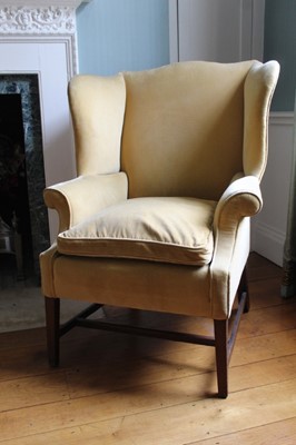 Lot 1377 - 19th century mahogany framed velvet upholstered wing armchair with serpentine top, outswept arms, loose cushion and square legs joined by stretchers, 82cm wide x 70cm deep x 113cm high