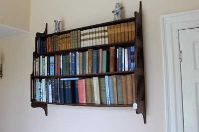 Lot 1381 - 19th century mahogany hanging waterfall fronted bookcase with three shelves and pierced sides with reeded borders, 122cm wide x 25cm deep x 116cm high