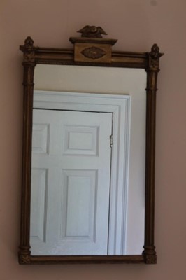 Lot 1382 - Regency gilt pier mirror with eagle surmount, reeded columns and floral rosettes, 80cm high x 48cm wide