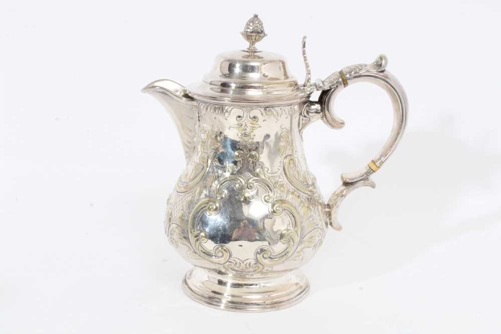 Lot 305 - Victorian silver plated hot water jug of baluster form, with chased scroll and foliate decoration