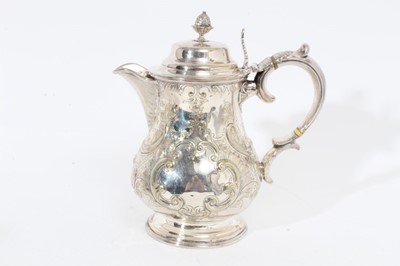 Lot 305 - Victorian silver plated hot water jug of baluster form, with chased scroll and foliate decoration