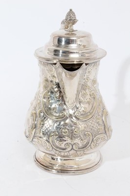 Lot 305 - Victorian silver plated hot water jug of baluster form, with chased scroll and foliate decoration