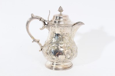 Lot 305 - Victorian silver plated hot water jug of baluster form, with chased scroll and foliate decoration