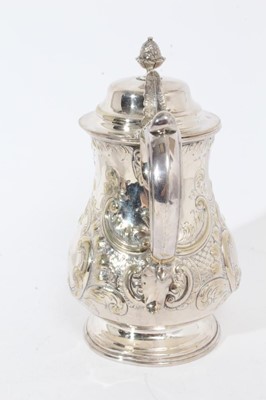 Lot 305 - Victorian silver plated hot water jug of baluster form, with chased scroll and foliate decoration