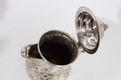 Lot 305 - Victorian silver plated hot water jug of baluster form, with chased scroll and foliate decoration