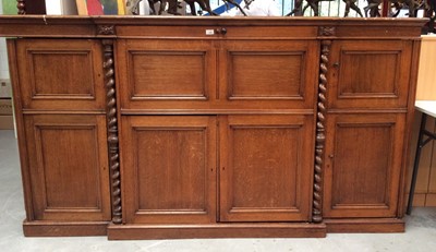 Lot 1398 - Unusual late Victorian oak writing cabinet, the central fall front enclosing fitted interior, above and flanked by an arrangement of cupboards enclosing fitted stationary compartments, on plinth ba...