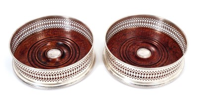 Lot 312 - Pair contemporary silver wine coasters of circular form, with pierced decoration