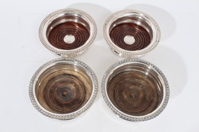 Lot 323 - Two pairs of contemporary silver plate wine coasters with gadrooned borders
