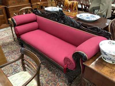 Lot 1527 - Regency mahogany framed double ended sofa upholstered in red fabric, the carved mahogany frame with acanthus leaf decoration and double scroll ends with bolster cushions, on carved and turned inv...