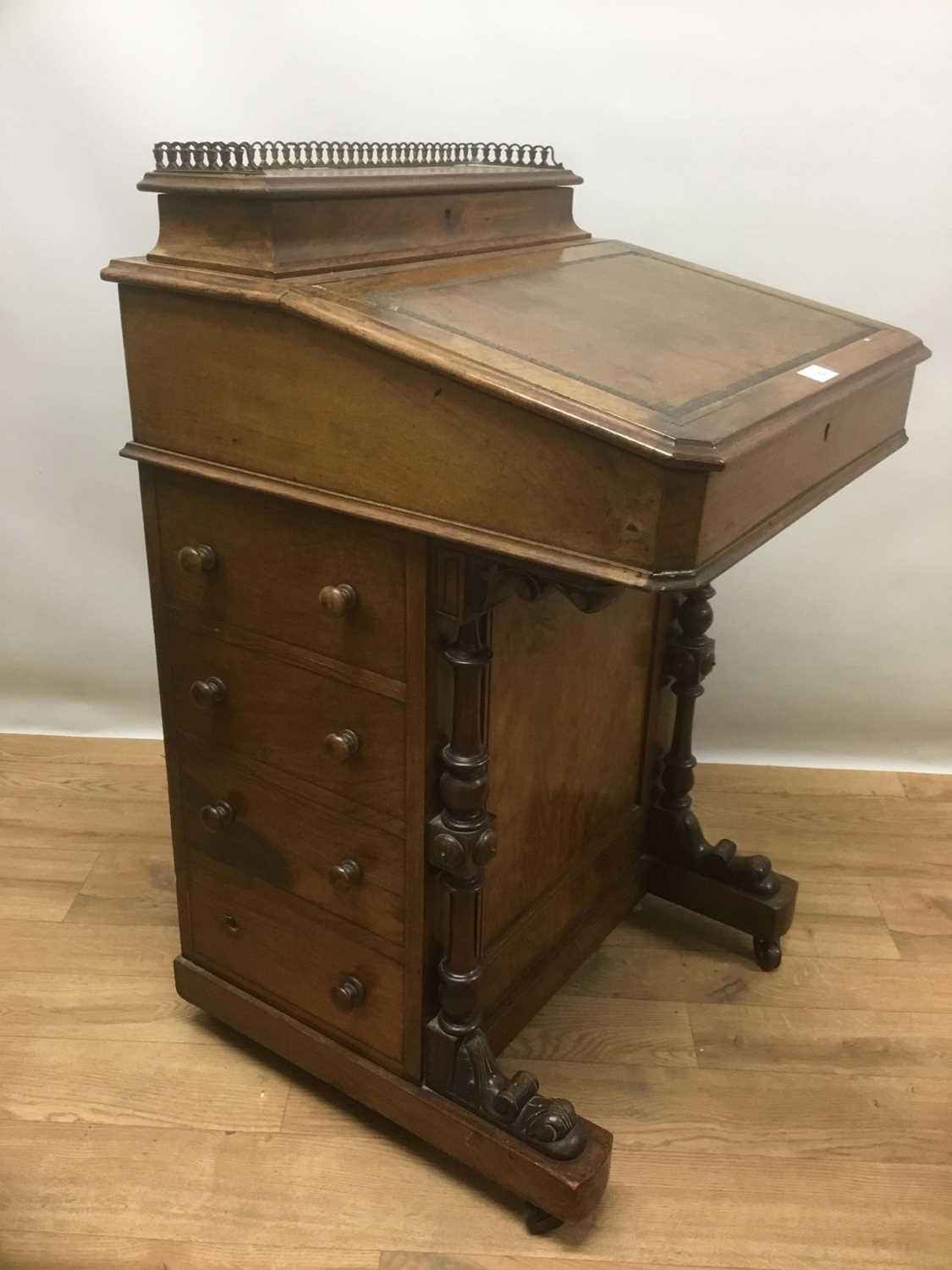 Lot 940 - Victorian walnut Davenport, the leather lined slope front enclosing fitted interior and stationary compartment, four drawers to side and carved and turned supports, on castors, 53cm wide x 54cm dee...