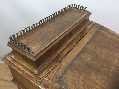 Lot 940 - Victorian walnut Davenport, the leather lined slope front enclosing fitted interior and stationary compartment, four drawers to side and carved and turned supports, on castors, 53cm wide x 54cm dee...