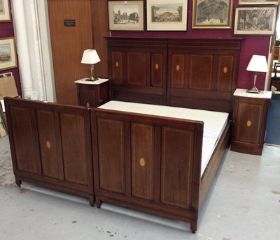 Lot 1424 - Pair of Edwardian inlaid mahogany single bedsteads, joining to make a super king-size bed, the moulded cornices above rectangular panels inlaid with oval motifs, with side rails and bases, 215cm lo...