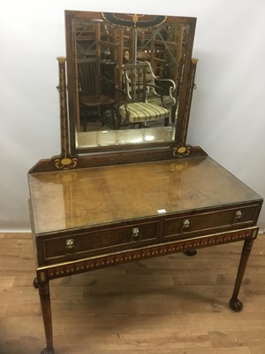 Lot 1426 - Early 20th century leather covered, painted and walnut dressing table, the Egyptian revival swing mirror above two drawers with lion mask handles, on turned legs and carved paw feet, 106cm wide x 5...