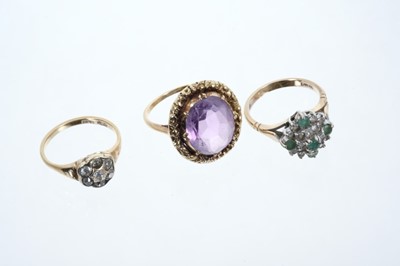 Lot 600 - Three rings to include a diamond cluster ring, emerald and diamond cluster ring and an amethyst single stone ring