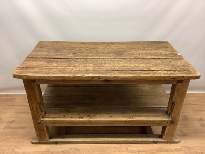 Lot 1461 - Rustic two tier pine kitchen table, with plank top and undertier raised on square supports, 133cm wide x 74cm deep x 75cm high