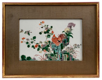 Lot 103 - Chinese famille verte porcelain plaque, Qing period, decorated with a cockerel standing on a rocky outcrop, with flowers and butterflies, in later frame, the plaque 22cm x 14.5cm