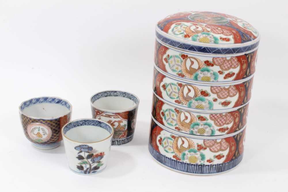 Lot 108 - Set of 19th century Japanese Meiji stacking boxes, together with three Imari cups