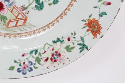 Lot 110 - 18th century Chinese famille rose porcelain dish, decorated with flowers and a fenced garden, 38.5cm diameter