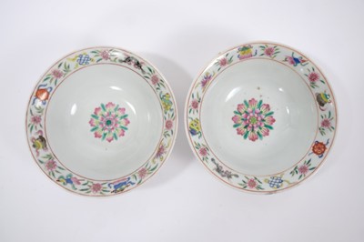 Lot 113 - Pair of Chinese famille rose porcelain bowls, c.1900, decorated with tropical birds, flowers and auspicious symbols, iron red seal marks to bases,  19cm diameter