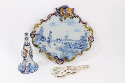 Lot 134 - Three 19th century French faience items, including a plaque painted with a scene of a figure and two goats with a harbour scene in the background, with scrollwork edge, measuring 35cm across, toget...