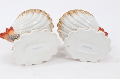 Lot 136 - Pair of Berlin porcelain salts, of shell form, painted with exotic birds and insects, supported by mythical dolphins on shaped bases, underglaze blue marks to bases, 6.5cm high